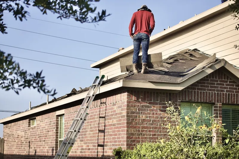 Professional roofer working on a residential roof in Langley Park